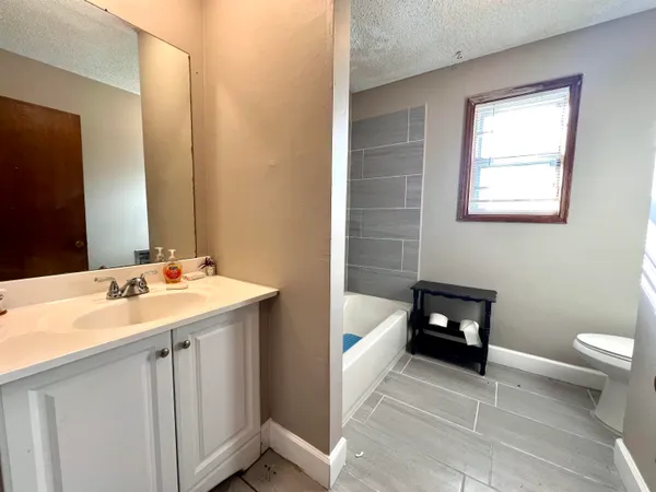 a bathroom with a sink toilet and tub