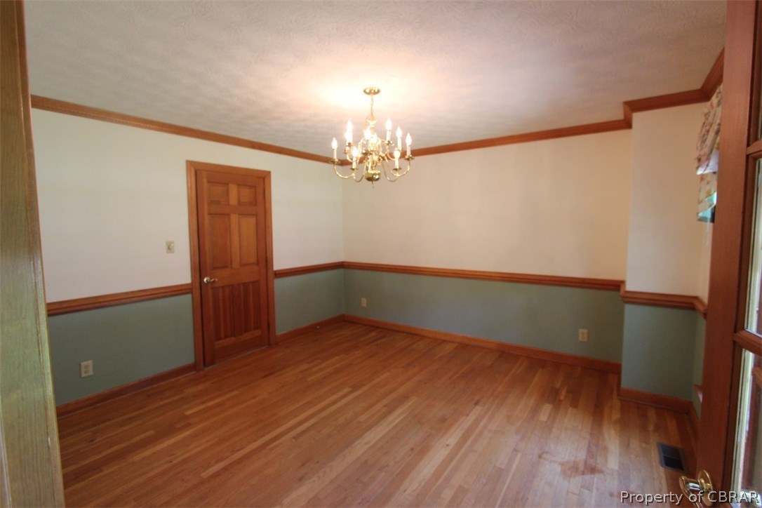 308 Tides Run Yorktown, VA 23692 - Photo 9 of 34 wooden floor in an empty room with a window