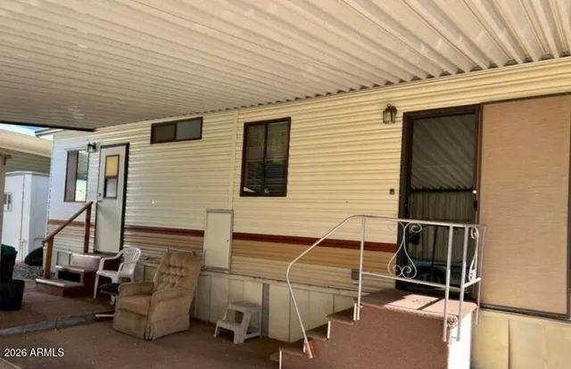 a backyard of a house with table and chairs