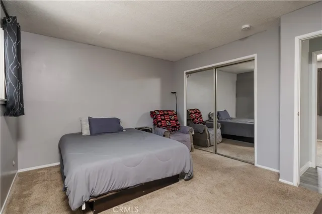 a bedroom with a bed and a lamp