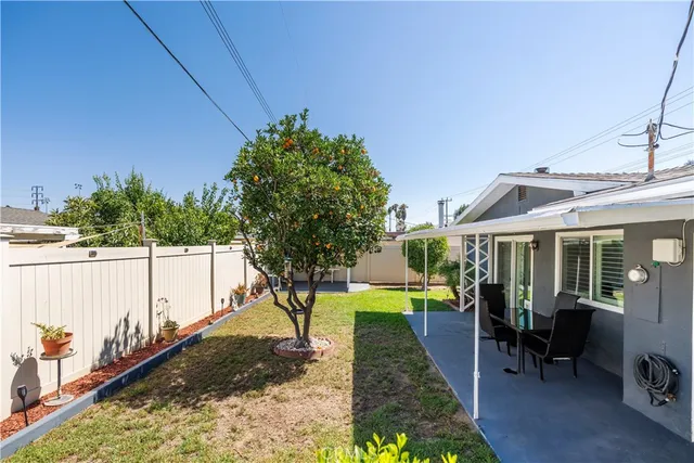 a view of a house with a wooden fence
