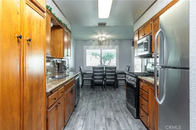 a kitchen with counter top space and wooden floor