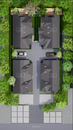 aerial view of a house with a yard and a large tree