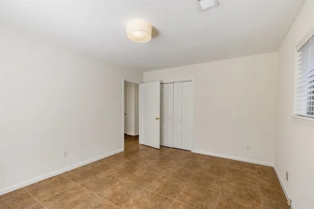 a view of an empty room and a window