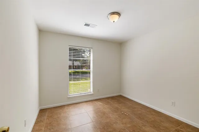 a view of an empty room with a window