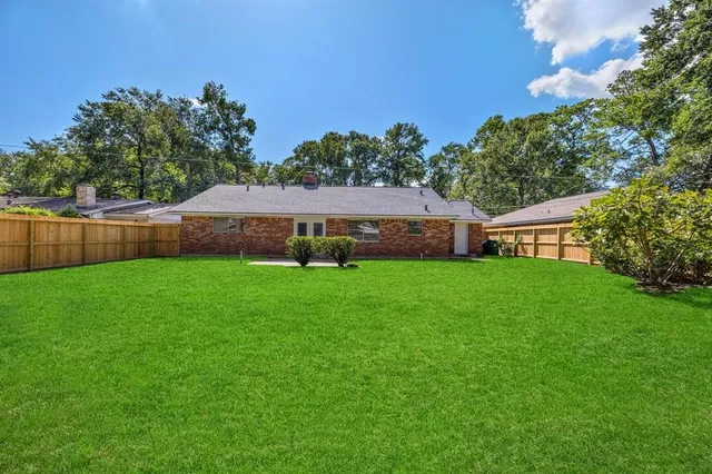 a view of an house with backyard space and sitting area