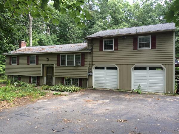 45 Gilson Road Groton, MA 01450 - Photo 1 of 9 a front view of a house with a yard and garage