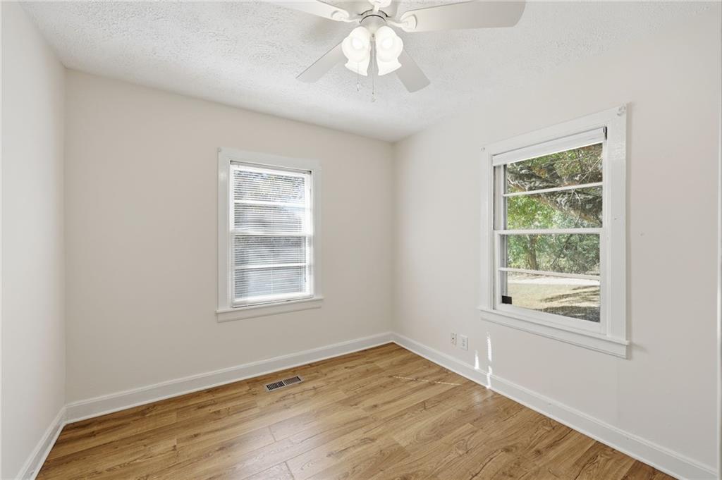 1304 Pine Valley Road Gainesville, GA 30501 - Photo 16 of 30 a view of an empty room with wooden floor and a window
