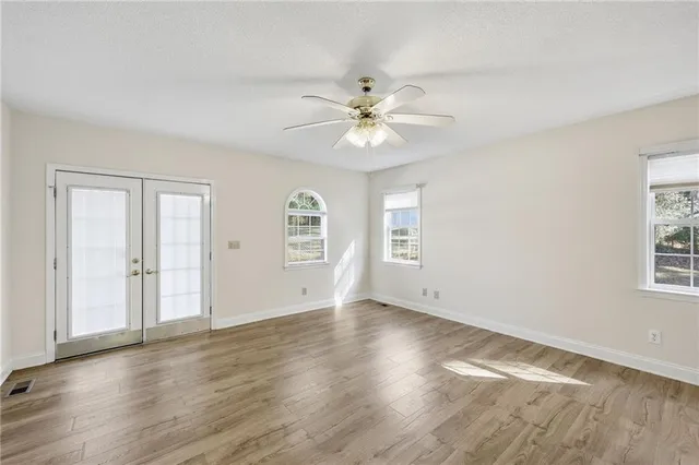 wooden floor in an empty room with a window