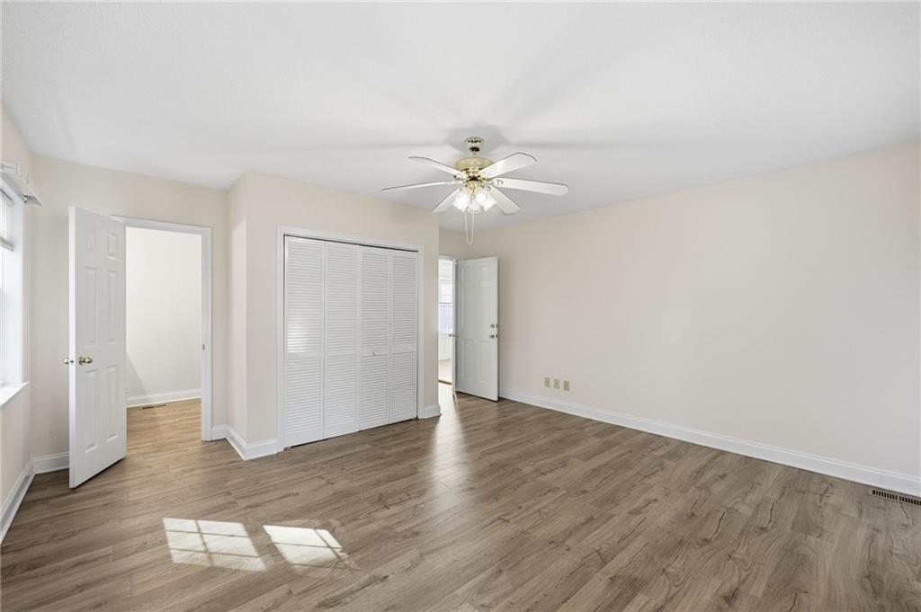 1304 Pine Valley Road Gainesville, GA 30501 - Photo 20 of 30 an empty room with wooden floor and ceiling fan