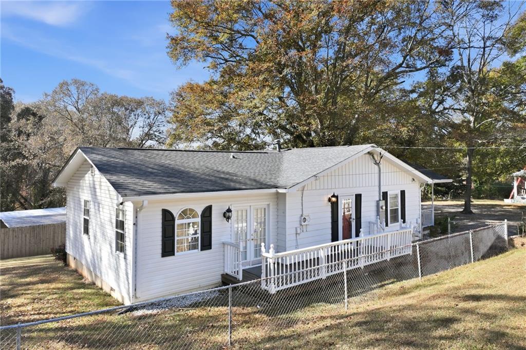 1304 Pine Valley Road Gainesville, GA 30501 - Photo 26 of 30 front view of a house with a fence