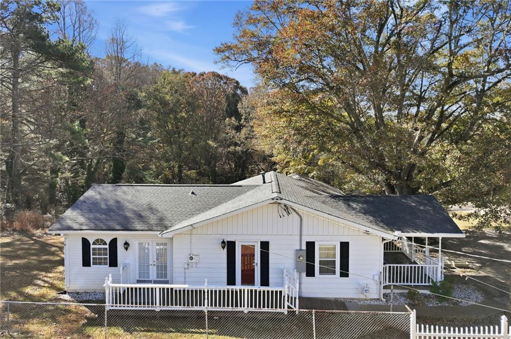 1304 Pine Valley Road Gainesville, GA 30501 - Photo 28 of 30 a view of a white house with a large windows and large tree