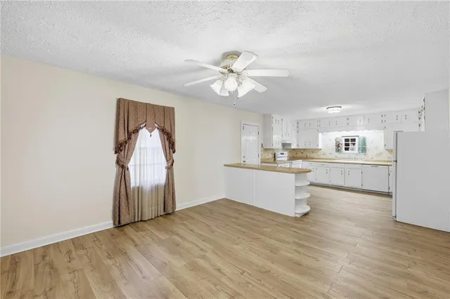 a view of kitchen with refrigerator and window