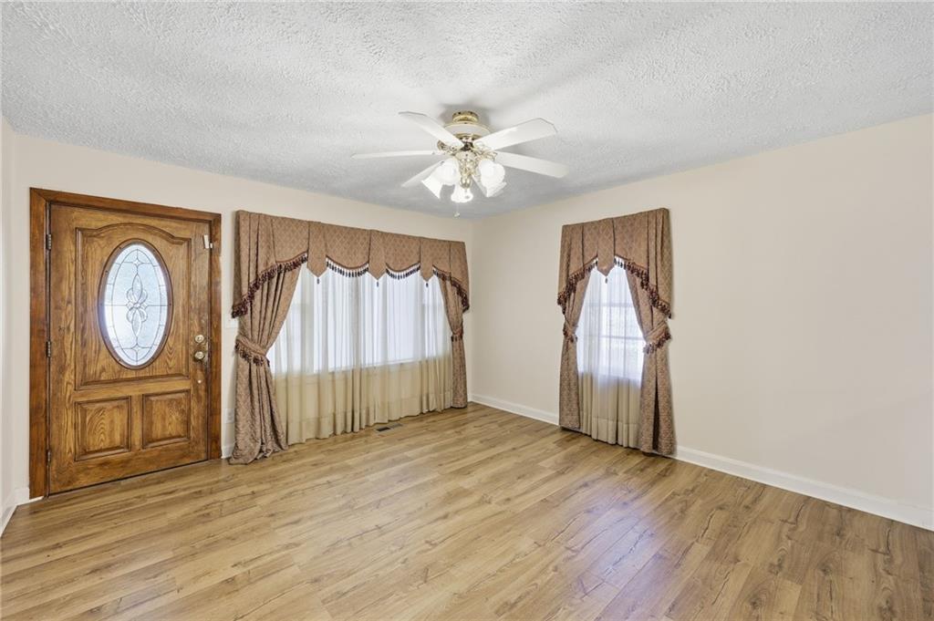1304 Pine Valley Road Gainesville, GA 30501 - Photo 7 of 30 wooden floor in an empty room with a window