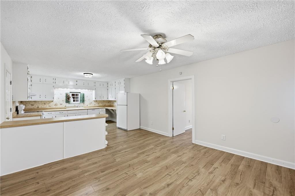 1304 Pine Valley Road Gainesville, GA 30501 - Photo 8 of 30 a kitchen with stainless steel appliances granite countertop a sink cabinets and wooden floor