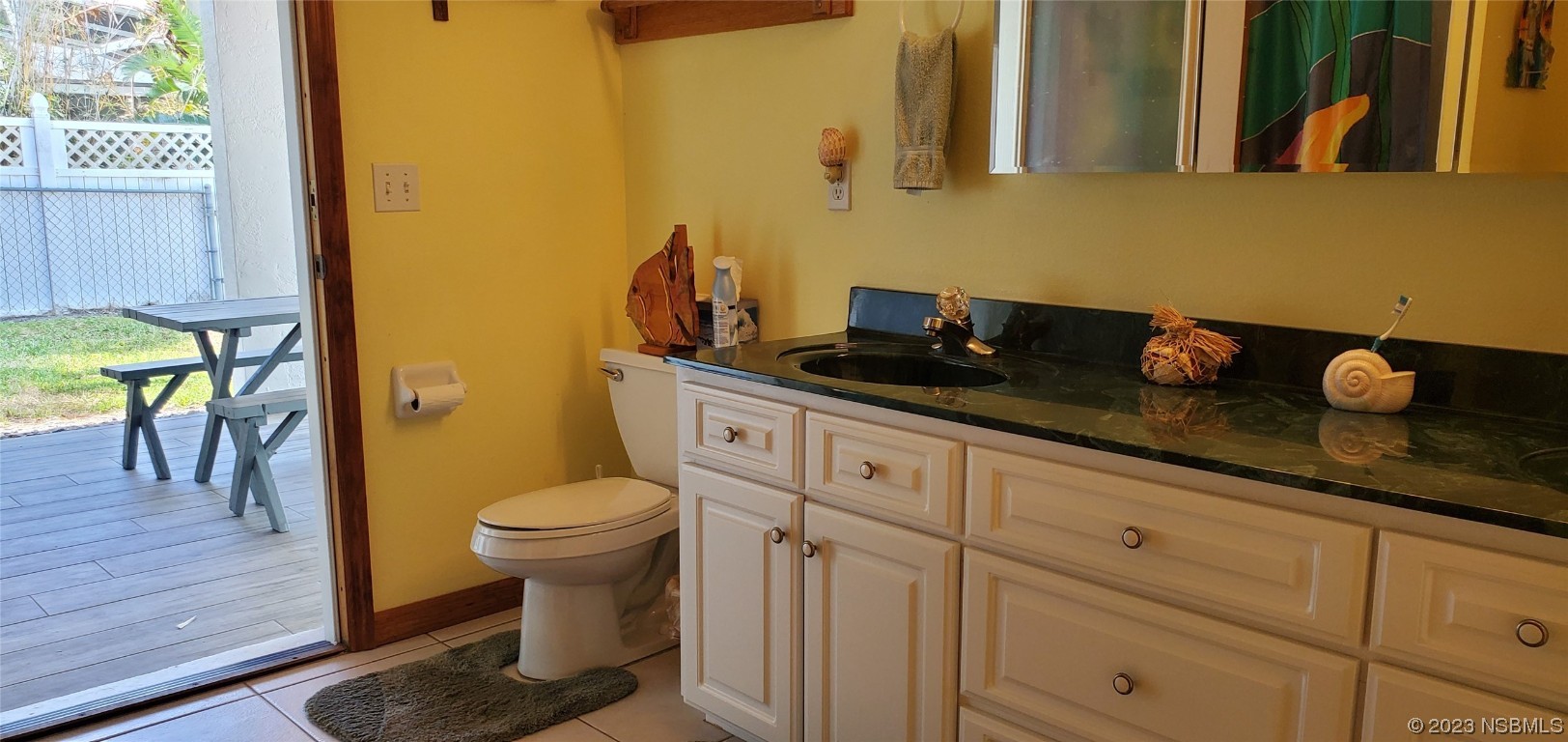 239 Kirkland Road New Smyrna Beach, FL 32169 - Photo 12 of 36 a bathroom with a granite countertop sink and a toilet