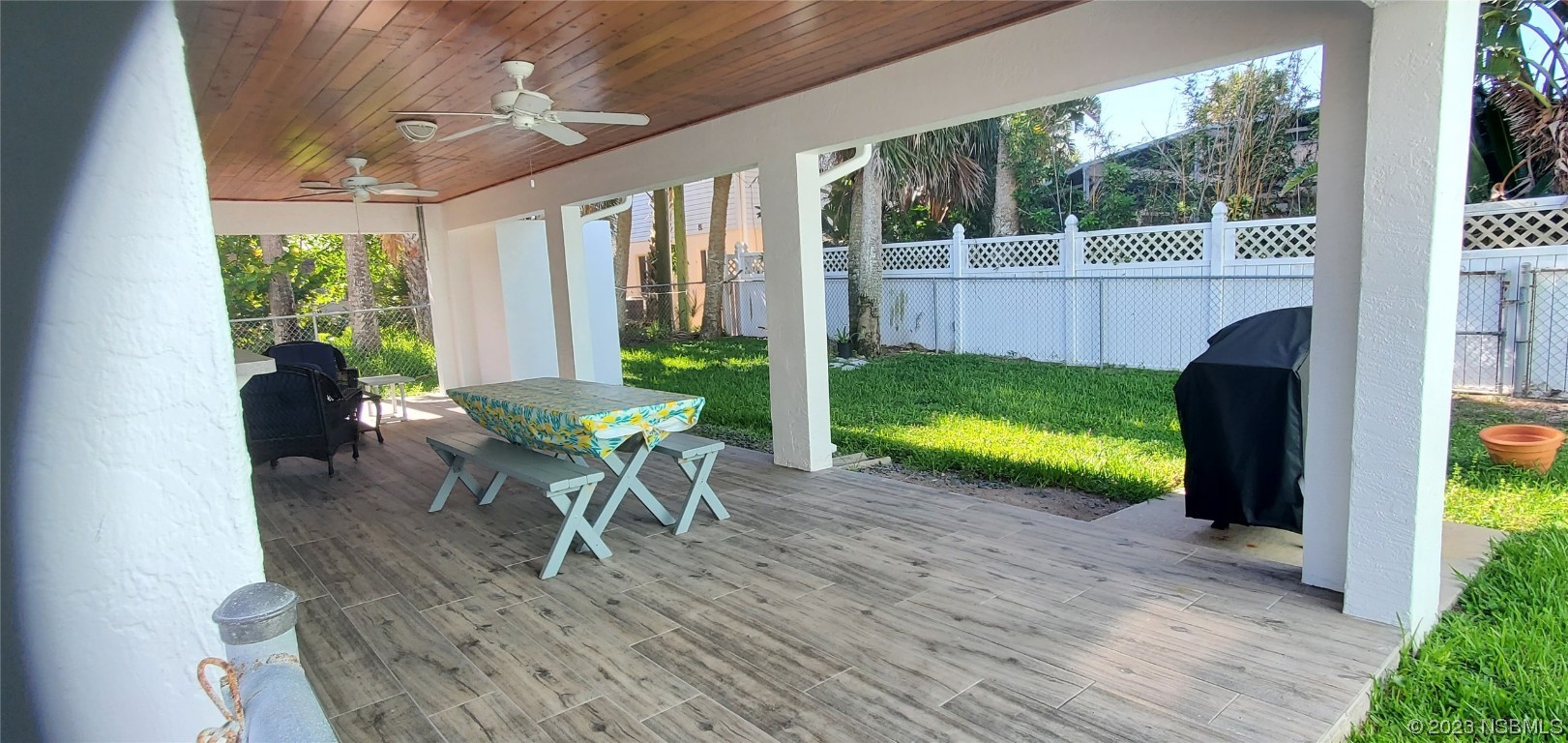 239 Kirkland Road New Smyrna Beach, FL 32169 - Photo 24 of 36 a view of a porch with furniture and a yard