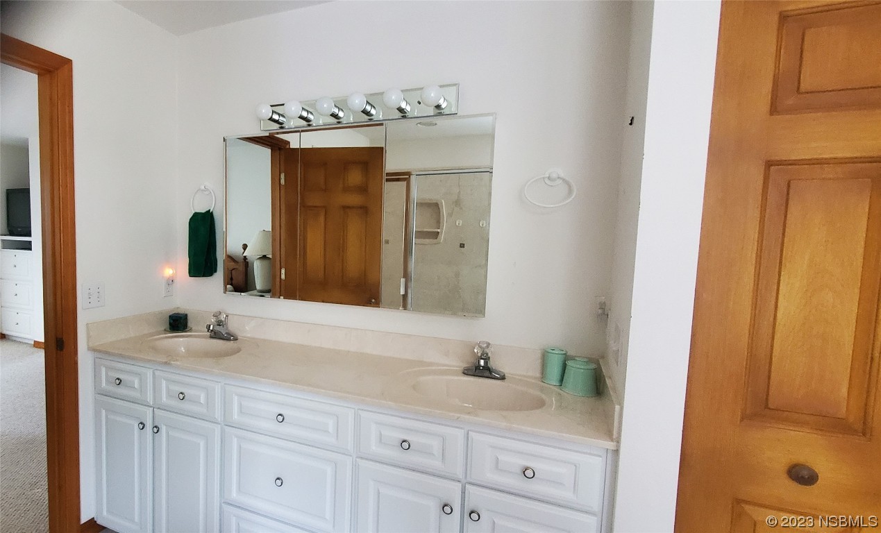239 Kirkland Road New Smyrna Beach, FL 32169 - Photo 26 of 36 a bathroom with a granite countertop sink vanity and mirror