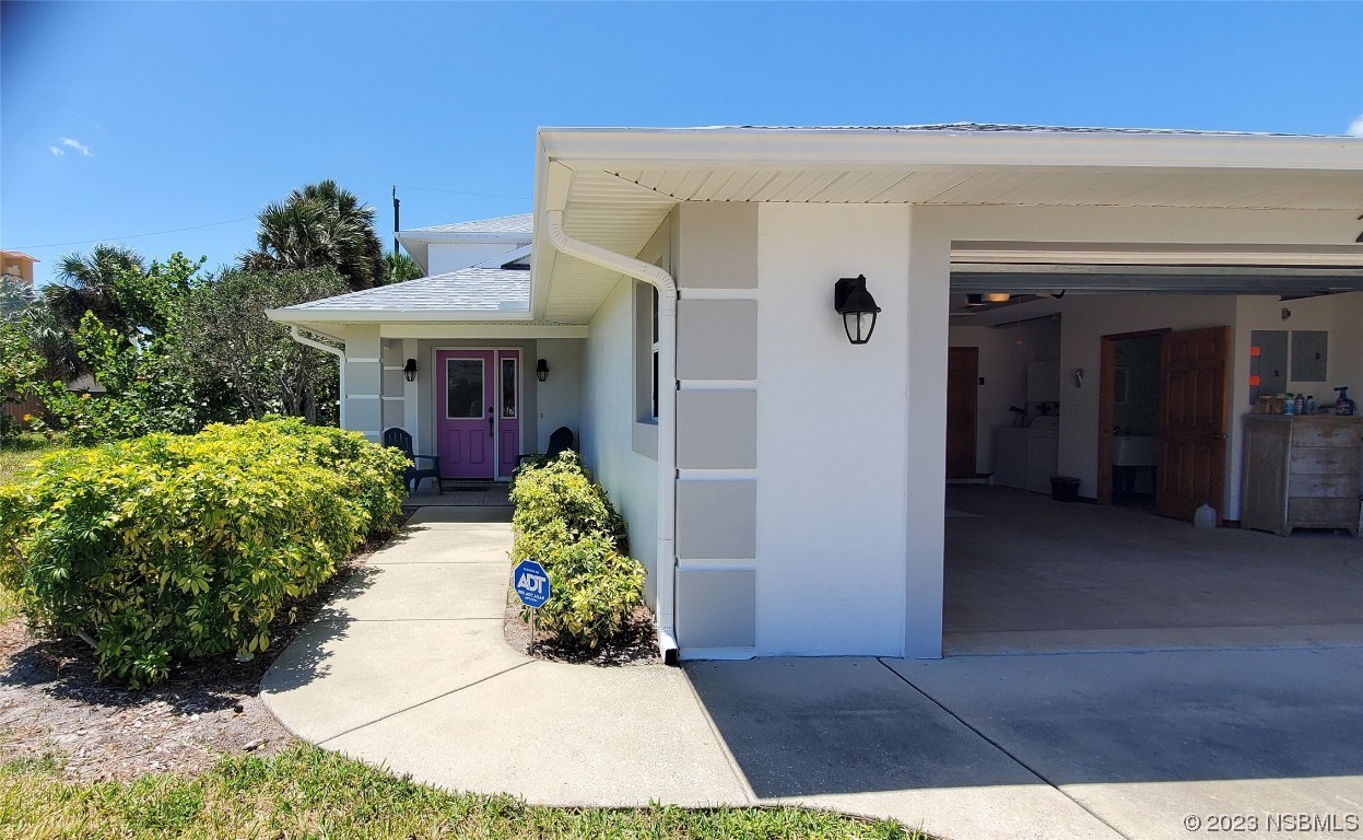 239 Kirkland Road New Smyrna Beach, FL 32169 - Photo 3 of 36 a front view of a house with a porch