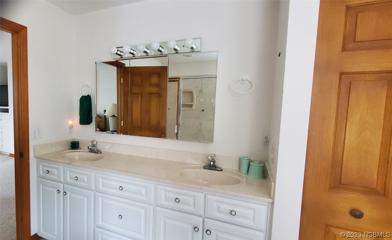 239 Kirkland Road New Smyrna Beach, FL 32169 - Photo 33 of 36 a bathroom with a sink vanity granite and a mirror