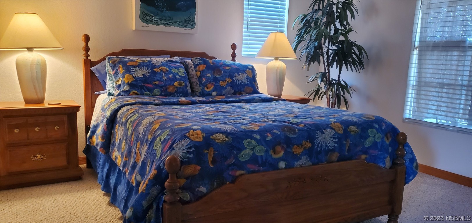 239 Kirkland Road New Smyrna Beach, FL 32169 - Photo 4 of 36 a bed sitting in a bedroom next to a window with potted plants