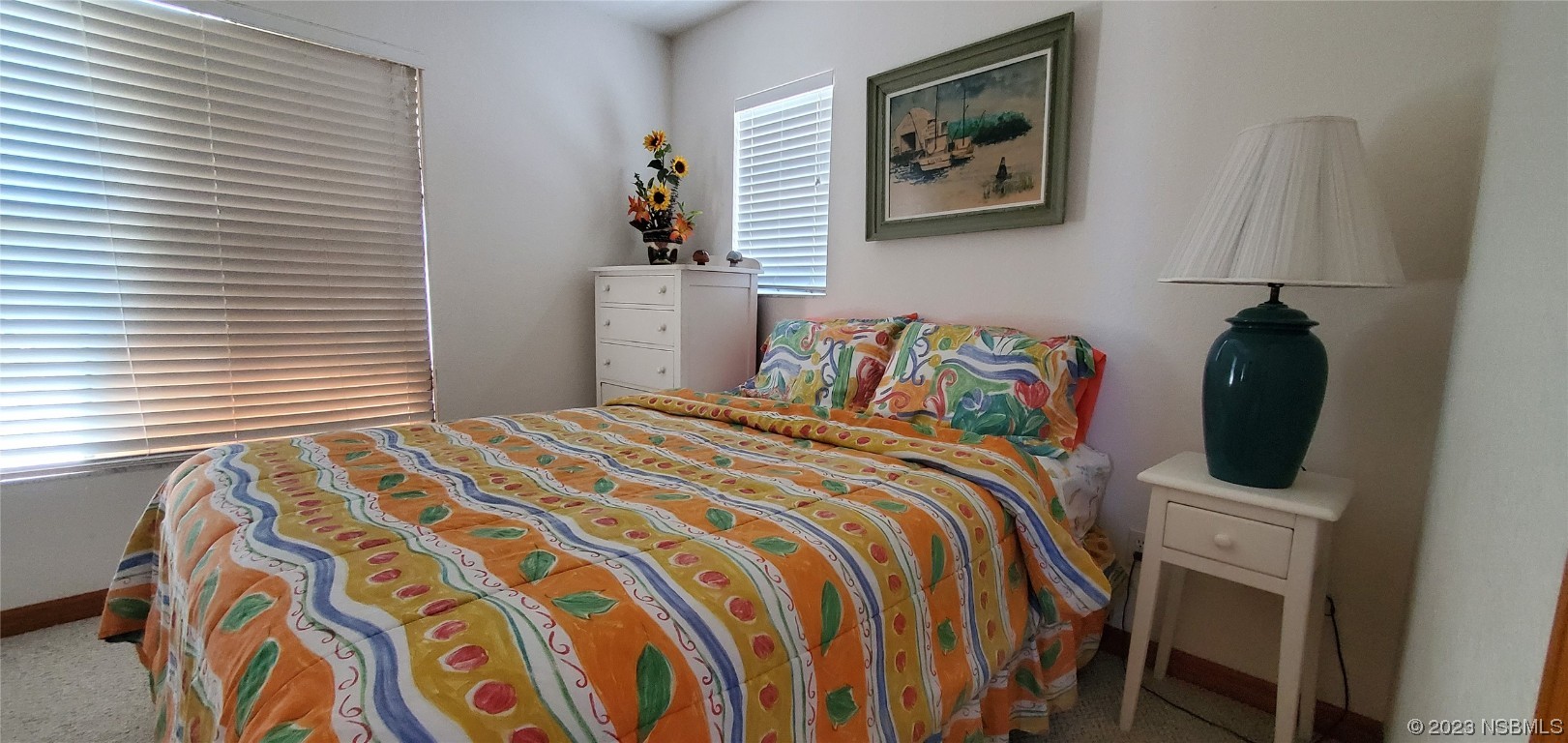 239 Kirkland Road New Smyrna Beach, FL 32169 - Photo 7 of 36 a bedroom with a bed and a lamp on dresser