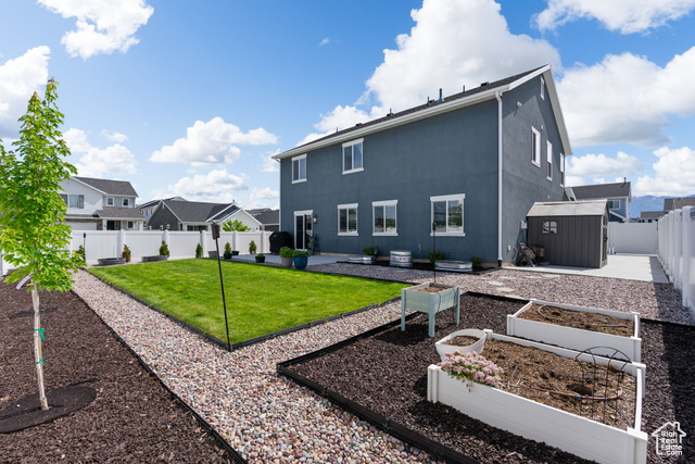 3456 South Linden Way Syracuse, UT 84075 - Photo 35 of 50 Back of property featuring a garden, a residential view, stucco siding, and a patio