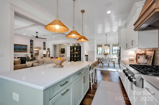 a kitchen with stainless steel appliances a stove a sink and a refrigerator