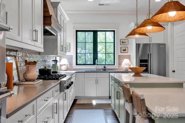 a kitchen with stainless steel appliances a sink stove and cabinets