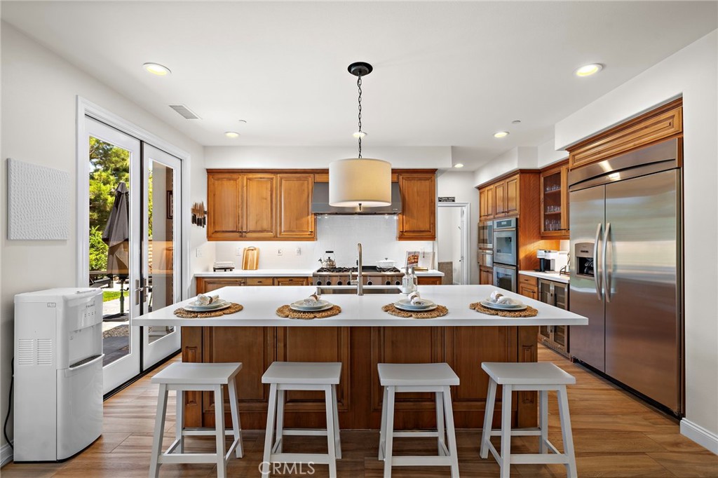 3 Tranquility Place Ladera Ranch, CA 92694 - Photo 17 of 63 a kitchen with granite countertop a dining table chairs and white cabinets