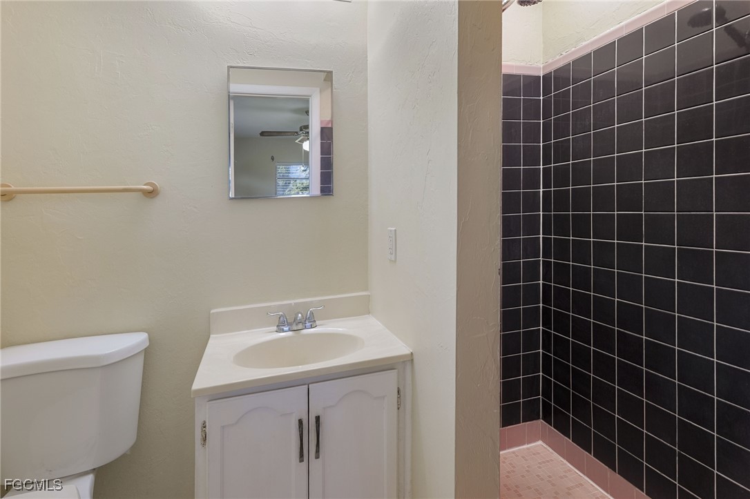 112 Clayton Avenue Lehigh Acres, FL 33936 - Photo 11 of 21 a bathroom with a sink toilet and shower