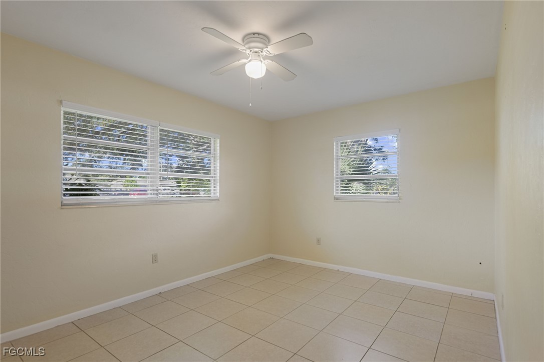 112 Clayton Avenue Lehigh Acres, FL 33936 - Photo 13 of 21 an empty room with a window and a fan