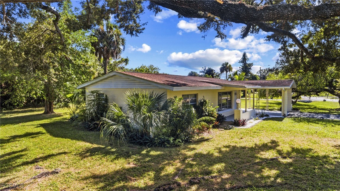 112 Clayton Avenue Lehigh Acres, FL 33936 - Photo 16 of 21 a view of a house with garden