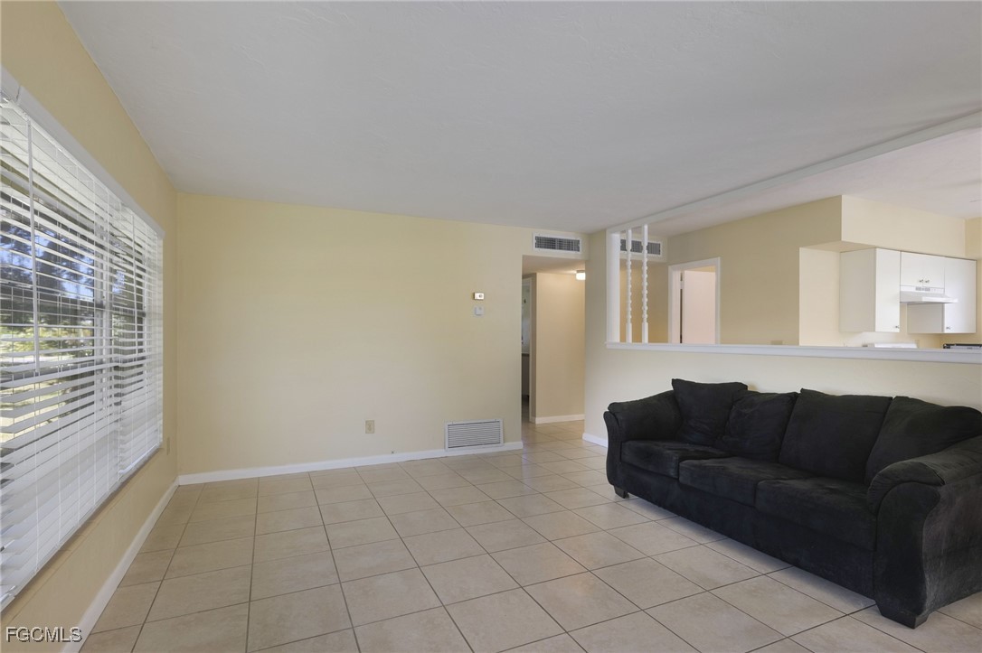 112 Clayton Avenue Lehigh Acres, FL 33936 - Photo 2 of 21 a living room with furniture and a window