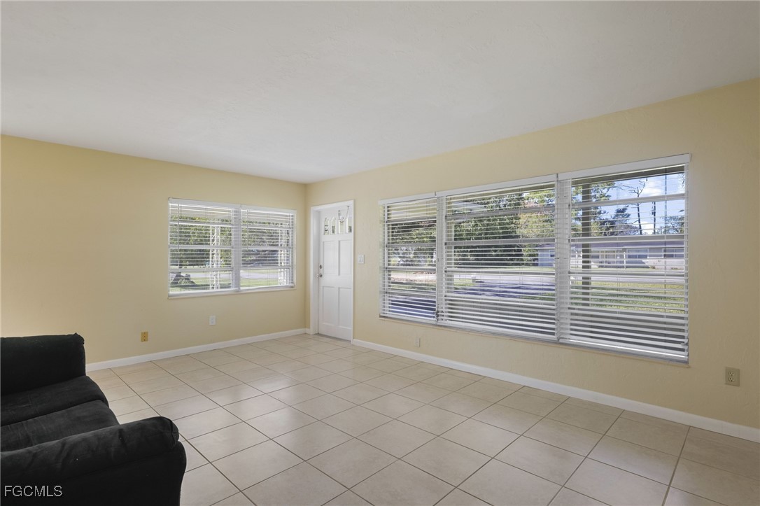 112 Clayton Avenue Lehigh Acres, FL 33936 - Photo 4 of 21 a view of an empty room with a window