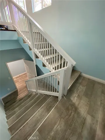 a bed sitting in a bedroom next to a lamp