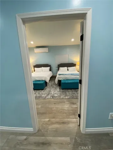 a bedroom with a large bed and a ceiling fan