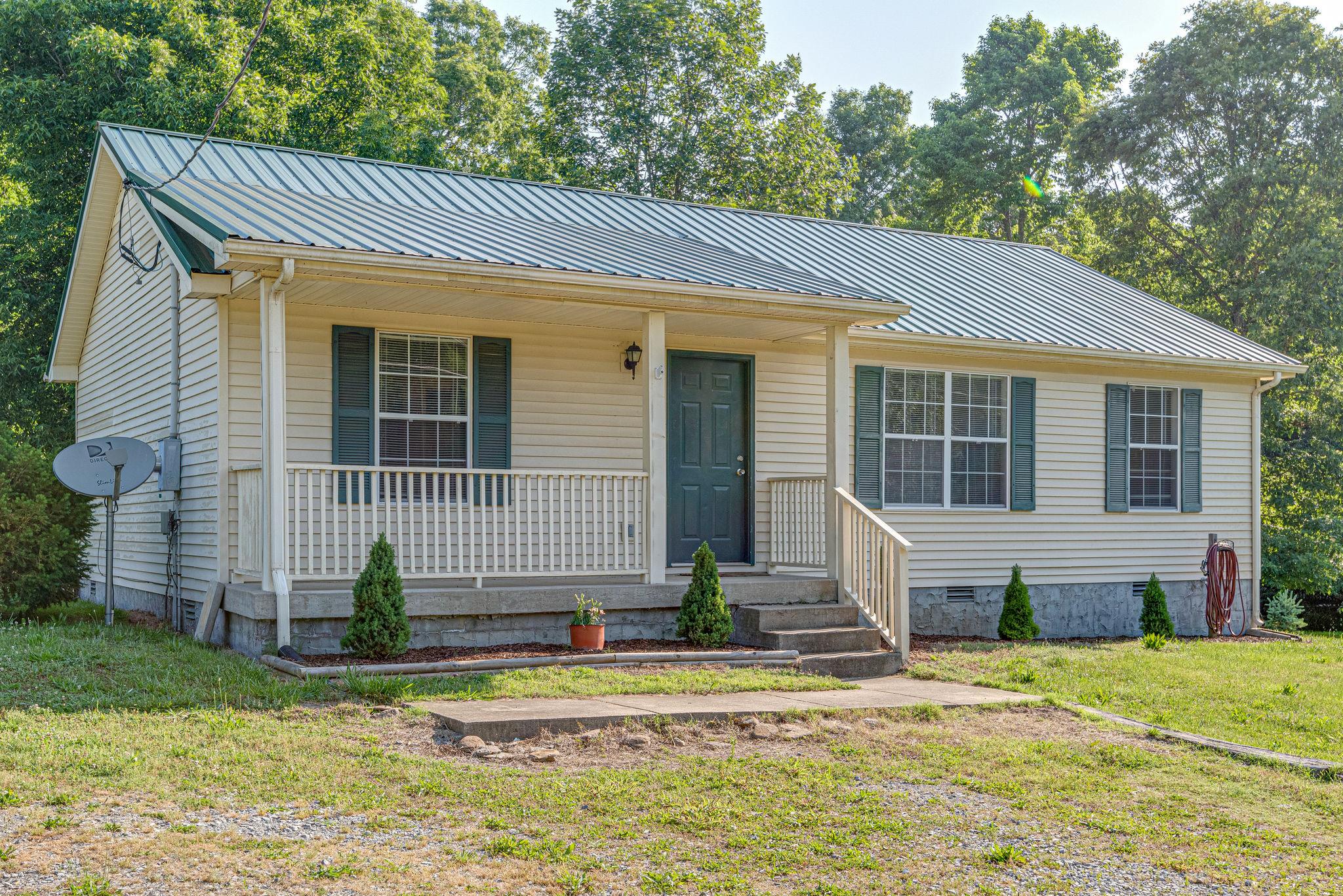 315 Preacher Road Charlotte, TN 37036 - Photo 3 of 26 Enjoy Tennessee Mornings on this rocking chair front porch.