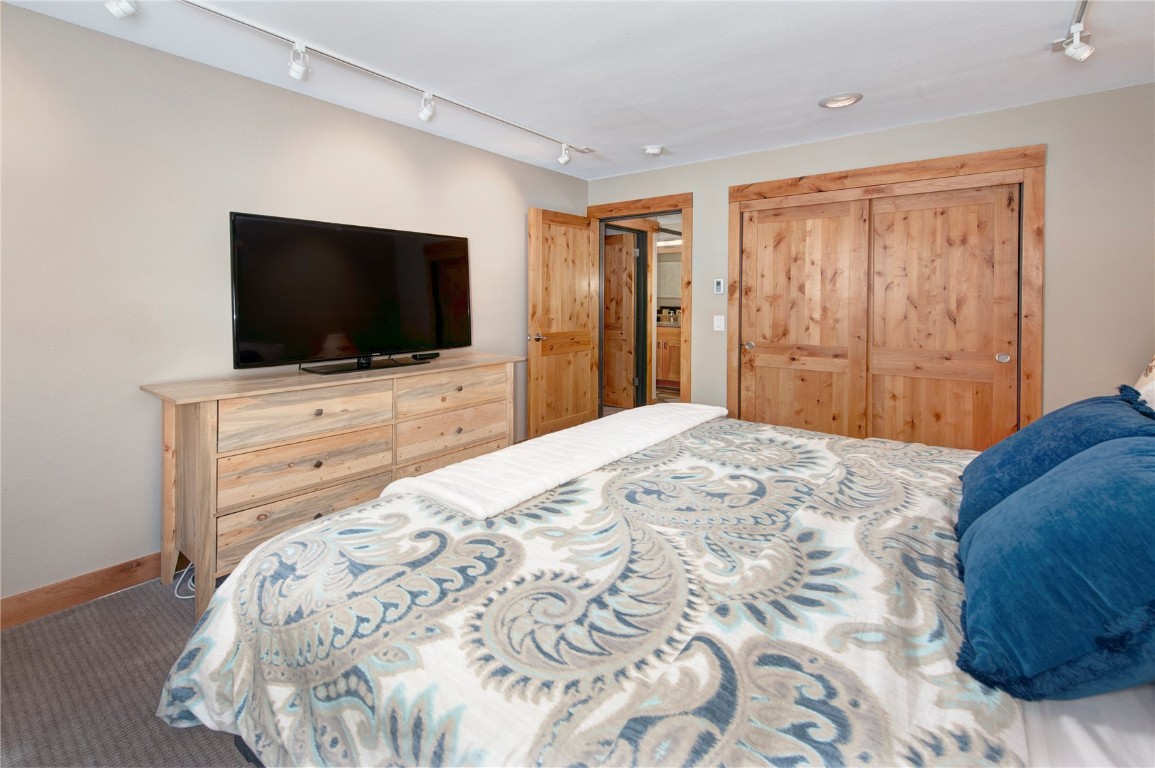 180 Tennis Club Road, Unit 1636 Keystone, CO 80435 - Photo 22 of 34 Carpeted bedroom with a closet and rail lighting