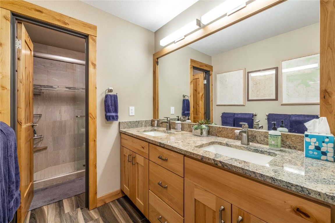 180 Tennis Club Road, Unit 1636 Keystone, CO 80435 - Photo 23 of 34 Bathroom with vanity, hardwood / wood-style floors, and an enclosed shower