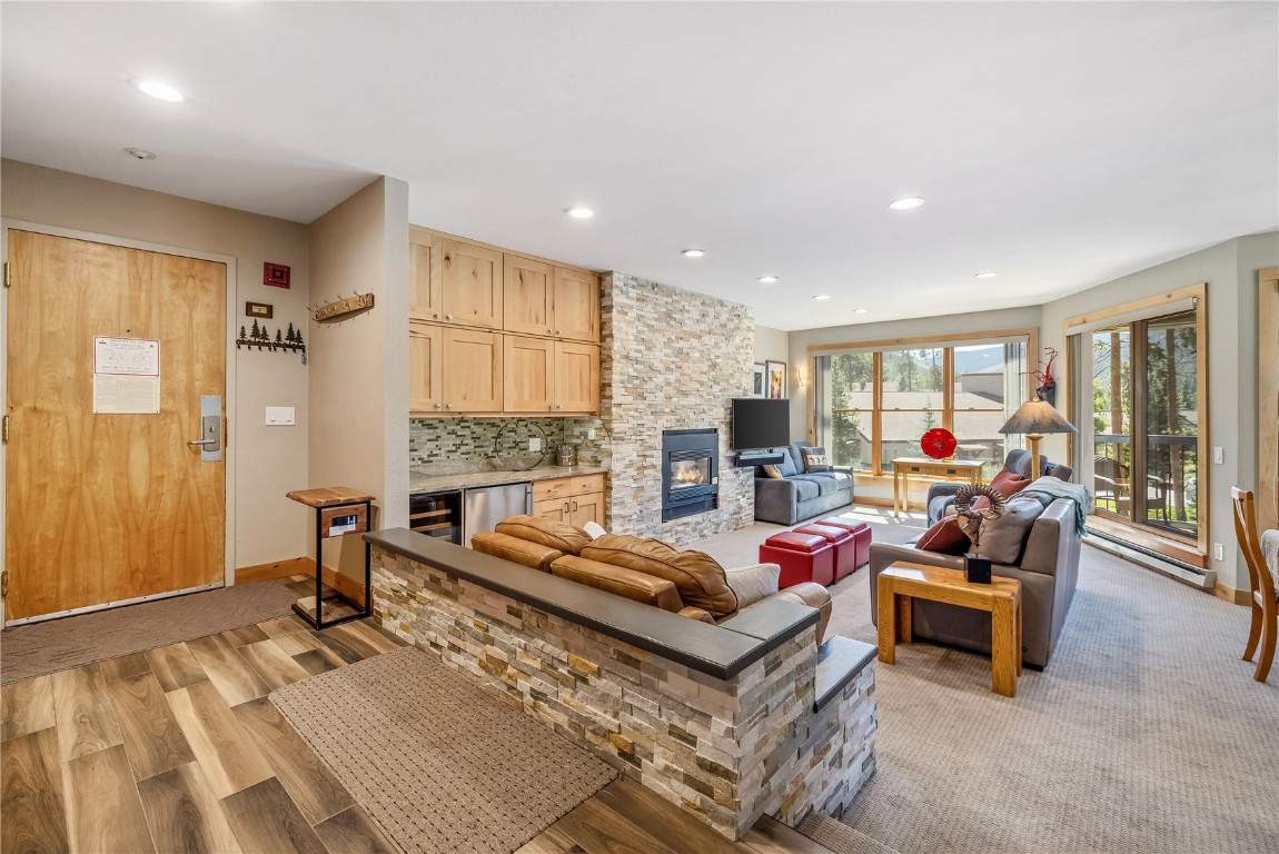 180 Tennis Club Road, Unit 1636 Keystone, CO 80435 - Photo 5 of 34 Living area featuring recessed lighting, baseboards, light wood-type flooring, and a stone fireplace