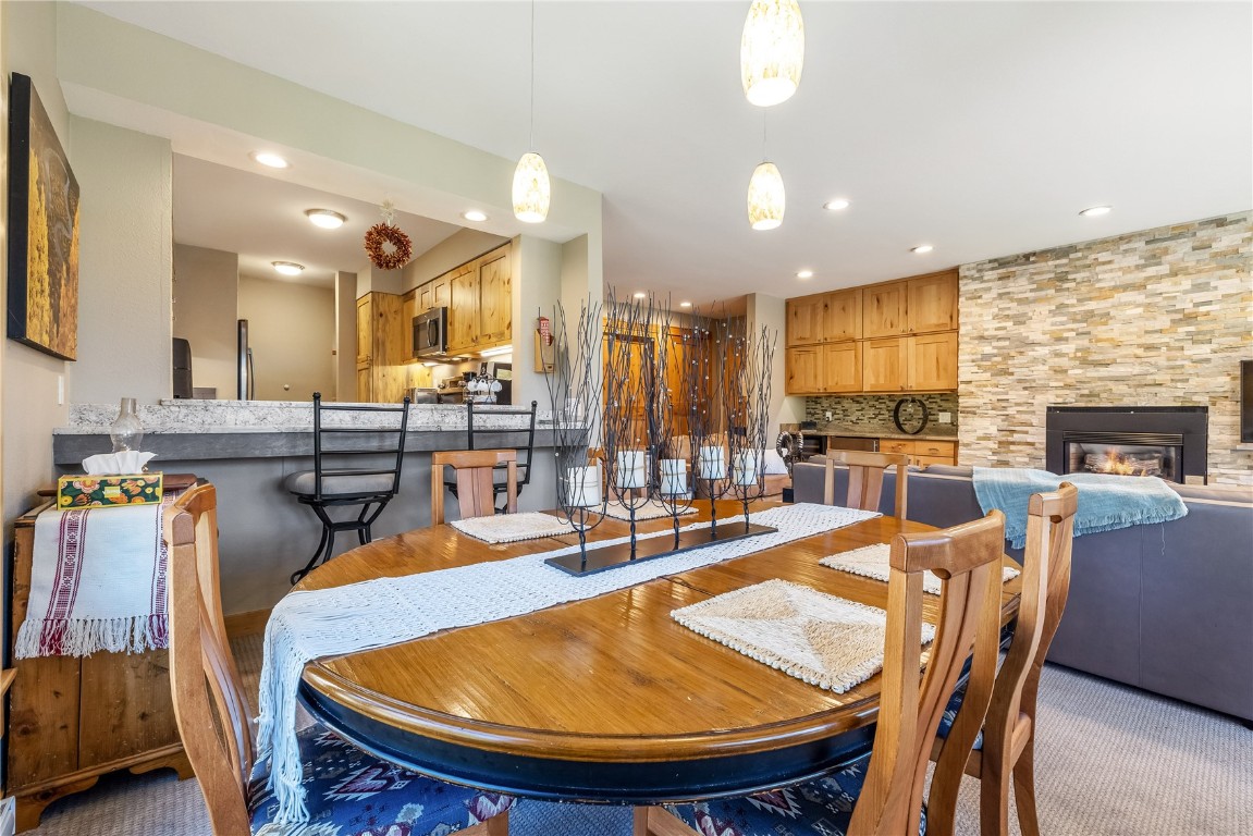 180 Tennis Club Road, Unit 1636 Keystone, CO 80435 - Photo 7 of 34 Carpeted dining room featuring a large fireplace