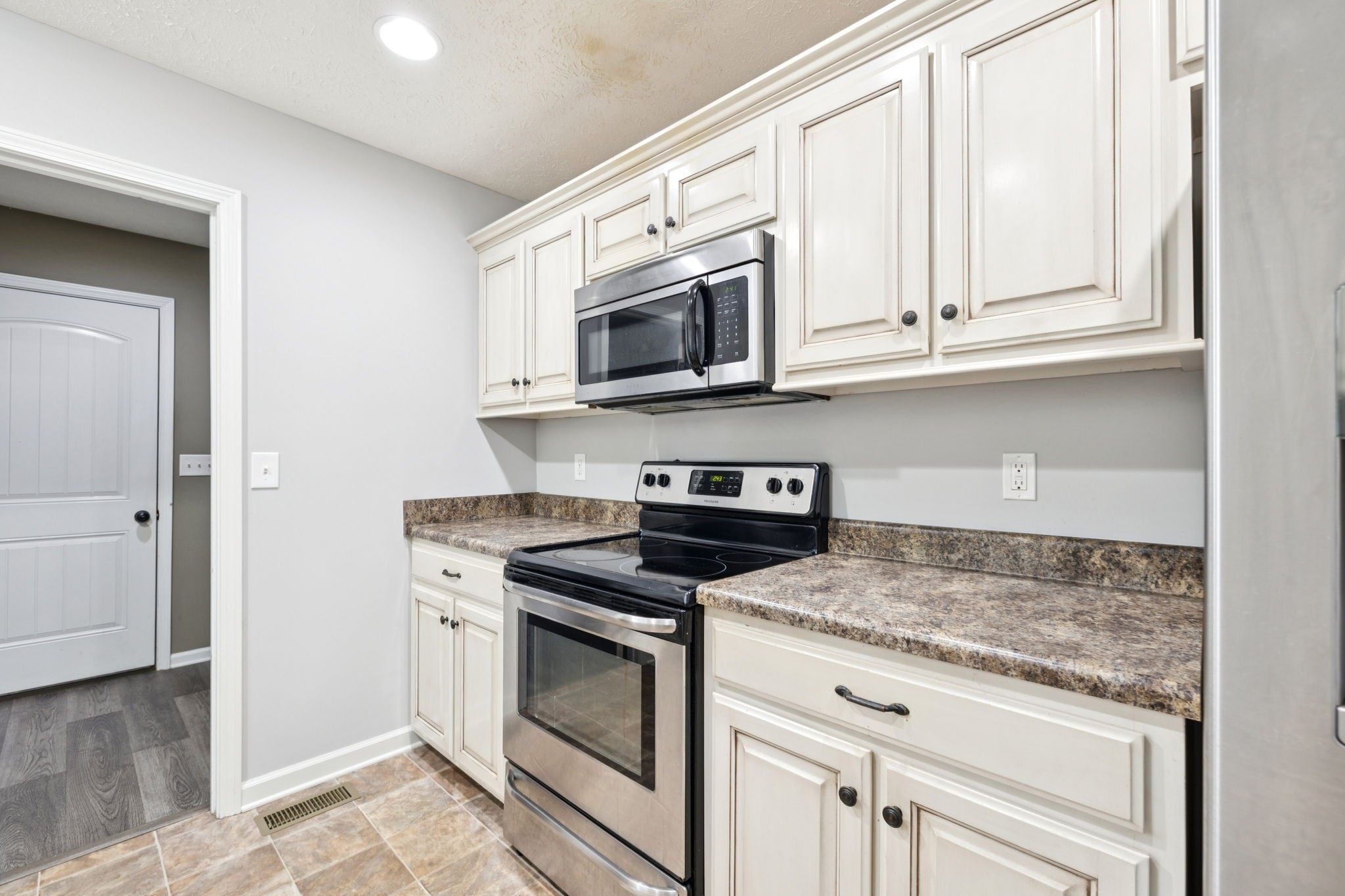 538 Indian Springs Circle Manchester, TN 37355 - Photo 13 of 59 a kitchen with stainless steel appliances granite countertop white cabinets and a stove top oven
