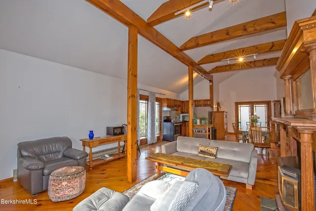 a view of living room kitchen with furniture and fireplace