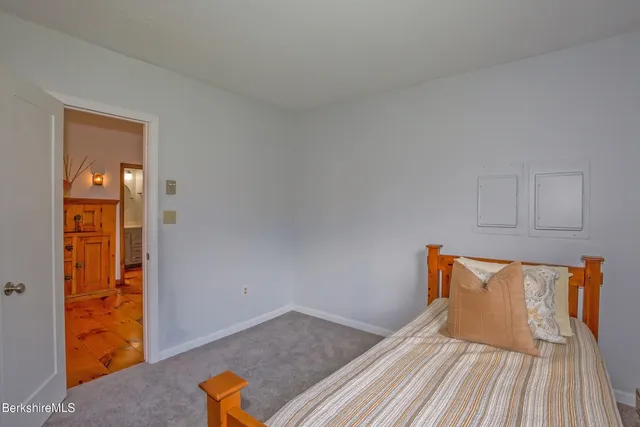 a living room with furniture a fireplace and a floor to ceiling window