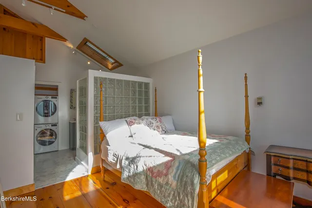a bedroom with a bed and a large mirror