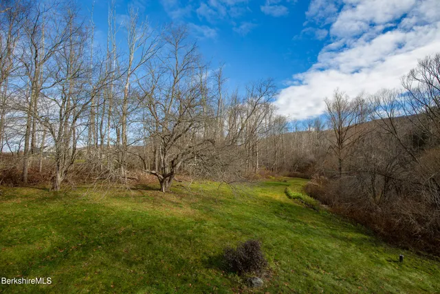 a view of a yard with wooden fence