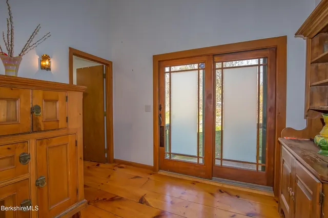a view of a dining room with furniture a chandelier and wooden floor