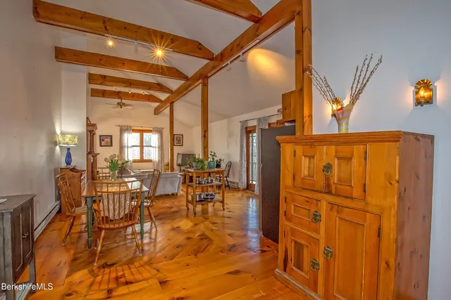 a living room with furniture stove and wooden floor