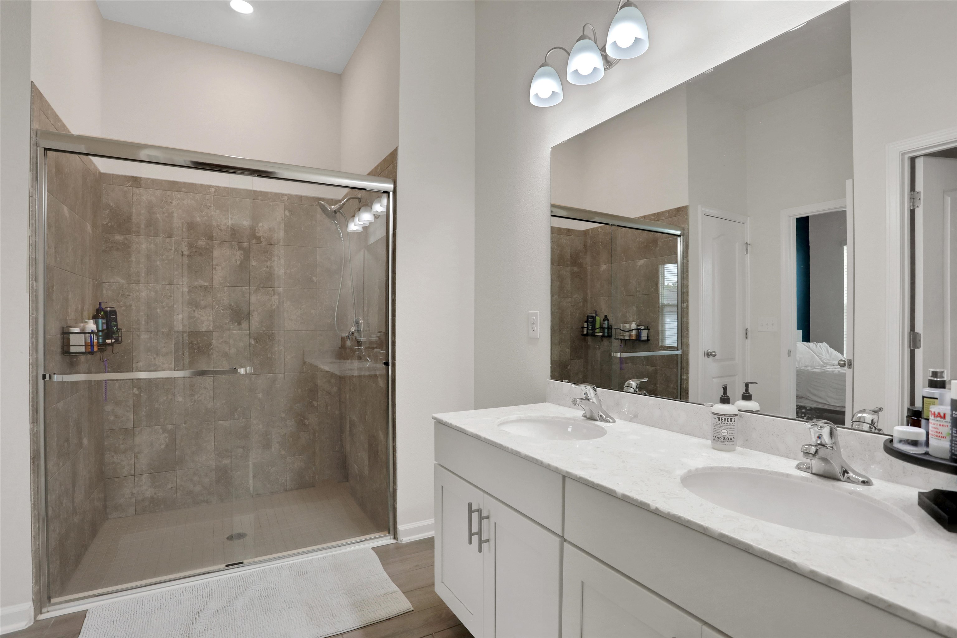 123 Hickory Ridge Road St. Augustine, FL 32084 - Photo 12 of 26 a bathroom with a granite countertop sink mirror and shower
